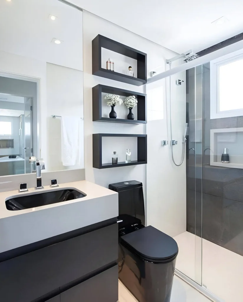 Modern small bathroom with black toilet, black floating vanity, black floating shelves, and a walk-in shower.