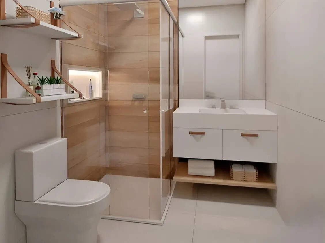 Modern small bathroom with white wall-mounted vanity, floating wooden shelves, and wood-look tile in the shower. Modern Small Bathroom Ideas