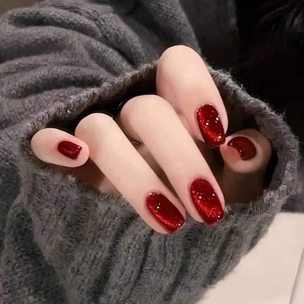 Deep red glitter nails with a luxurious and cozy shine.