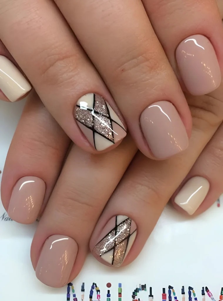 Elegant nude nails with geometric glitter and black line accent.