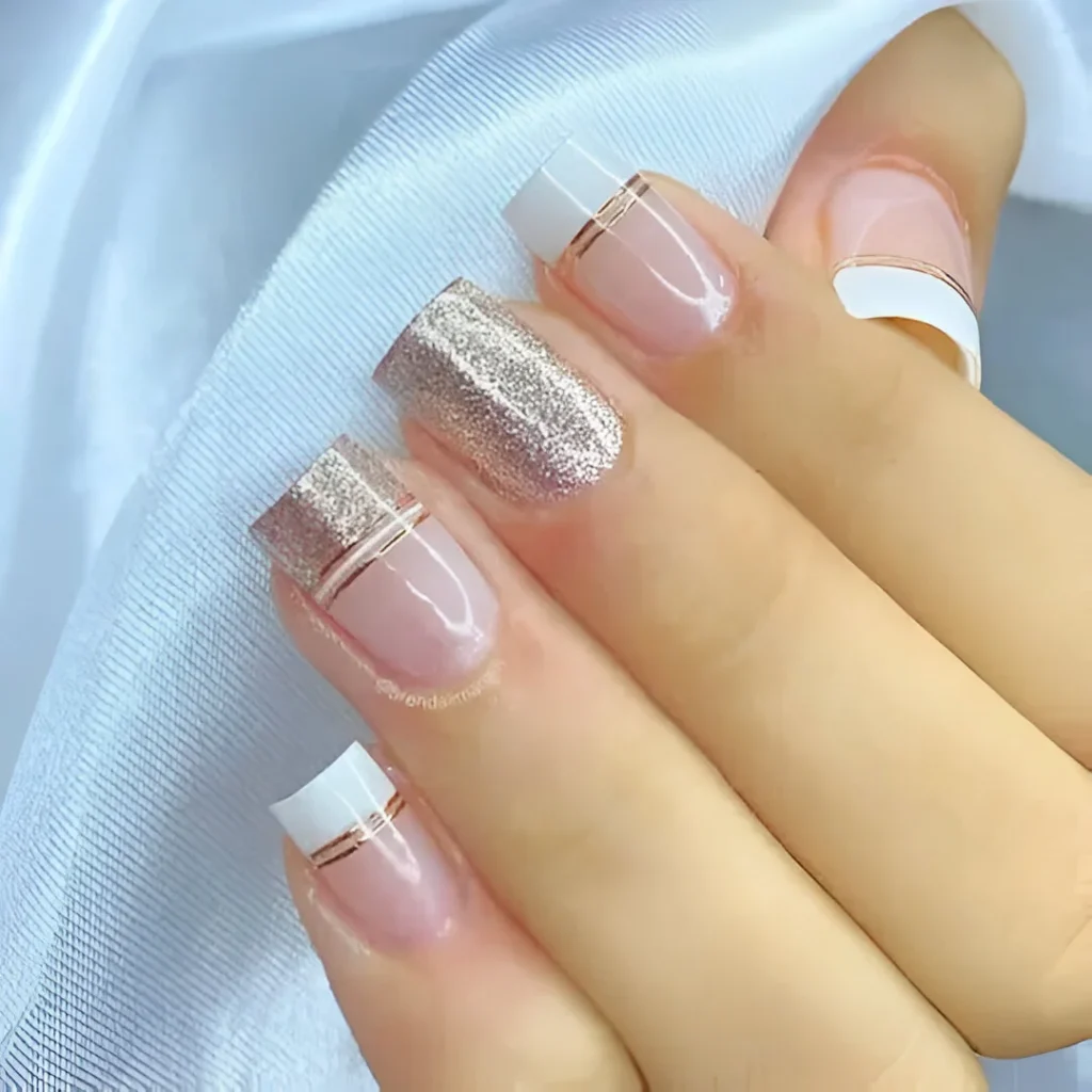 Chic and classy French manicure with rose gold stripes and glitter accent nail.