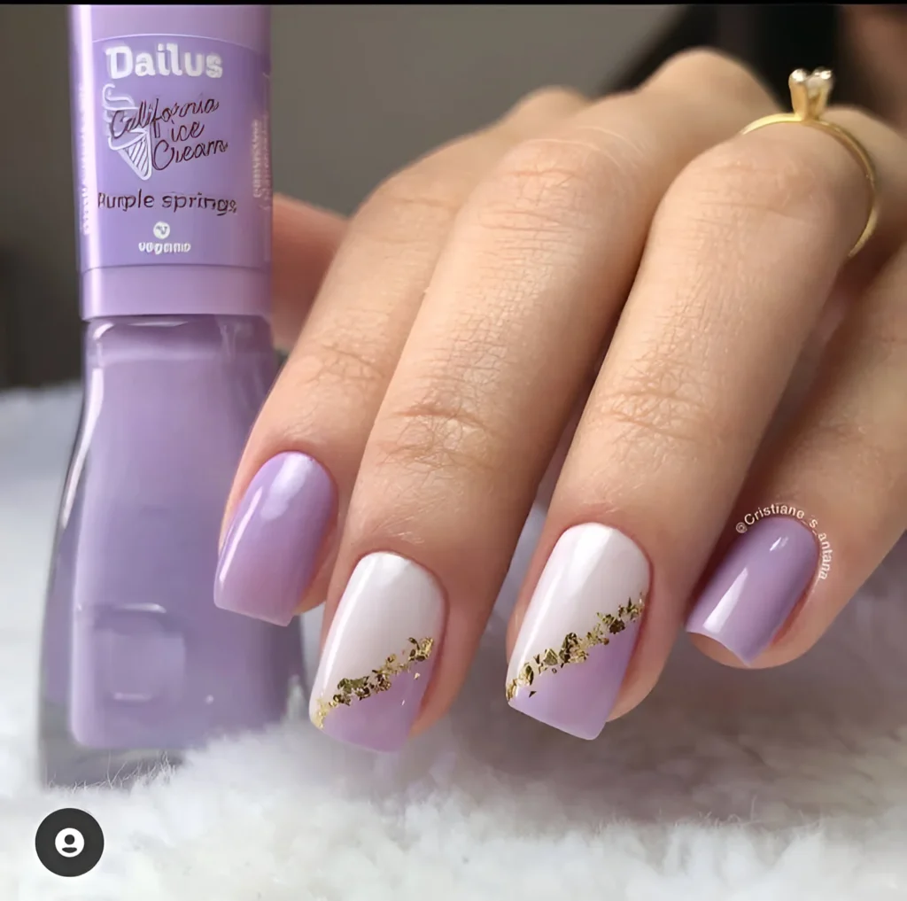 Classy nail design with lavender, white, and gold leaf accents.