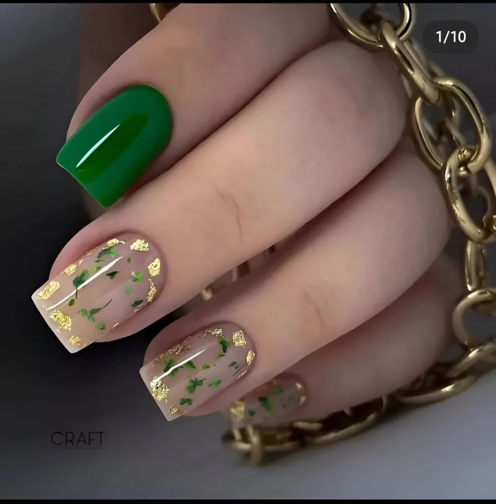 Elegant nails with emerald green and nude botanical gold leaf design.