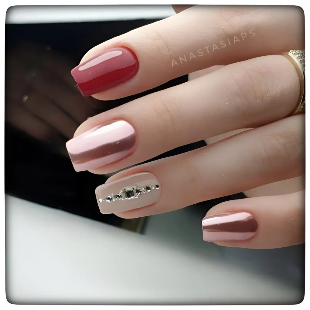 Chic nails with cranberry, rose chrome, and rhinestone accents.