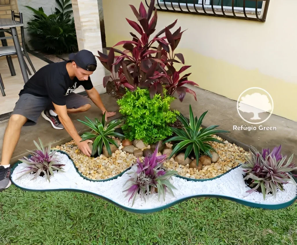 Garden decor with a colorful, curving border of plants, pebbles, and rocks. The center bush is: Golden Dewdrop