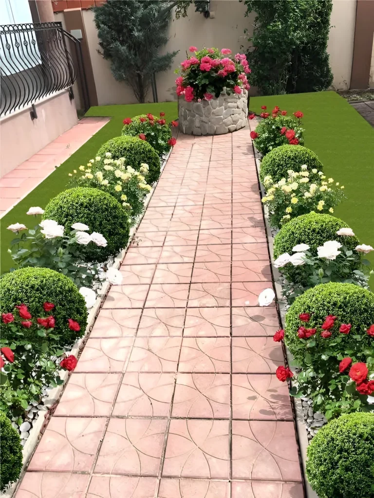 Garden decor with a pathway bordered by rounded shrubs and a raised stone planter.