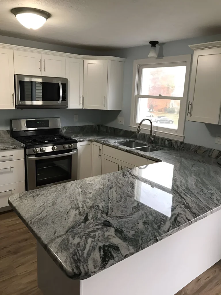 Double bowl undermount kitchen sink made of stainless steel, paired with a granite countertop.