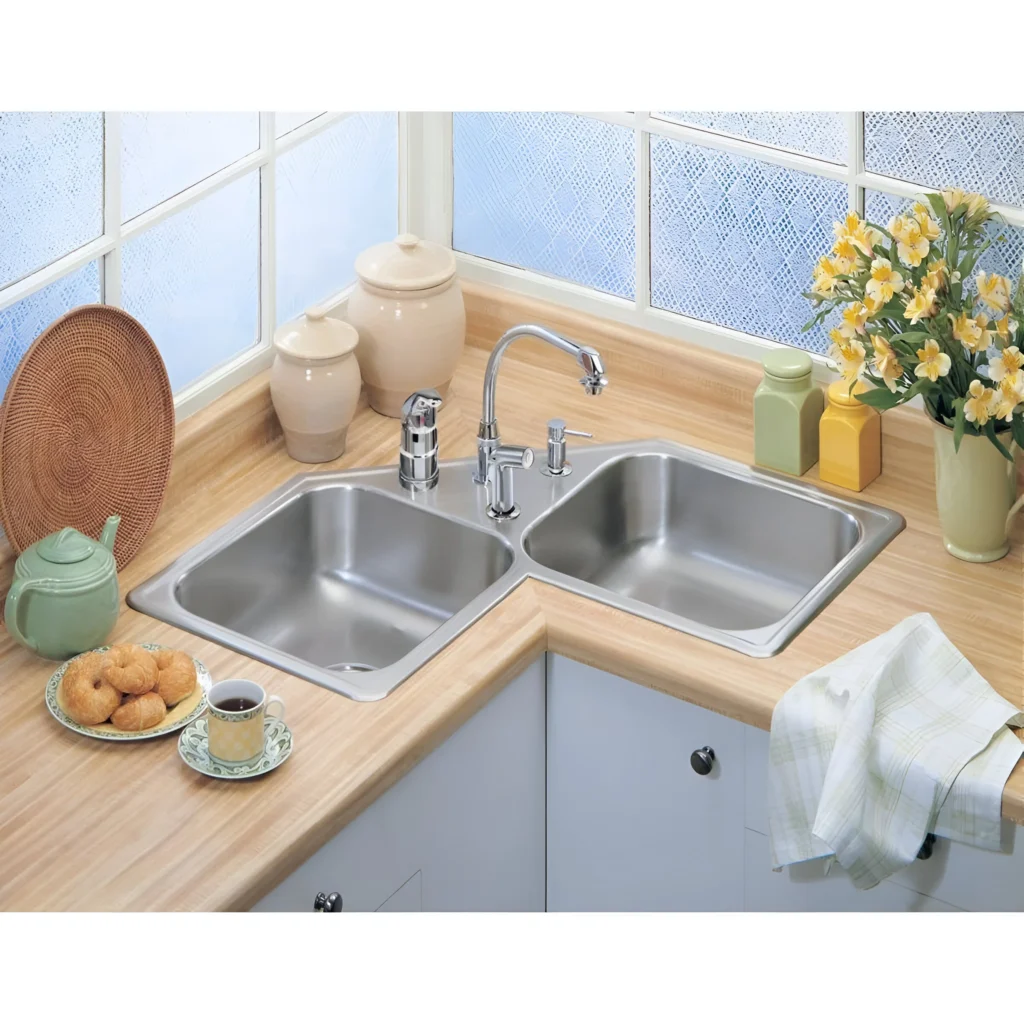 Double bowl drop-in kitchen sink in a corner configuration, featuring a high-arc faucet.