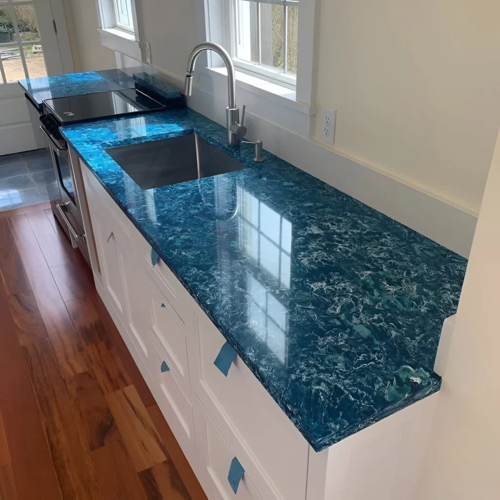 Kitchen sink with vibrant blue Cambria Skye Quartz countertop and an undermount stainless steel sink.