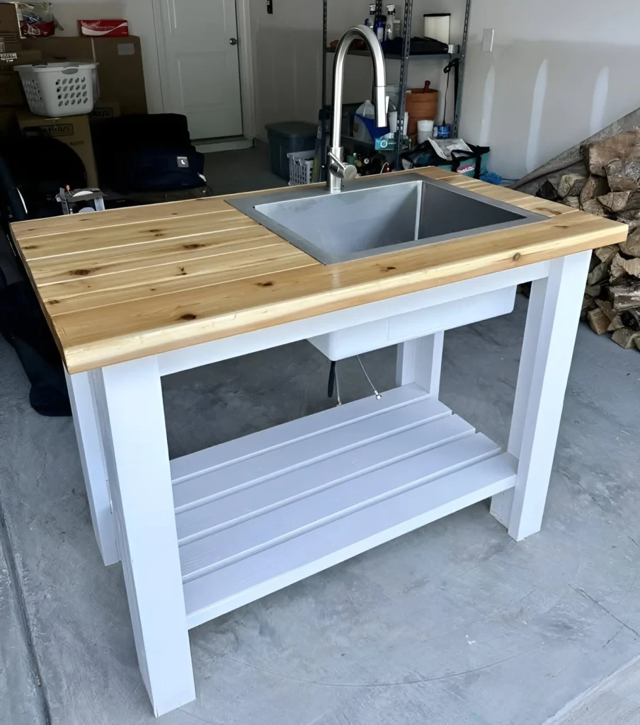 Outdoor kitchen sink with a butcher block countertop and a drop-in stainless steel sink.