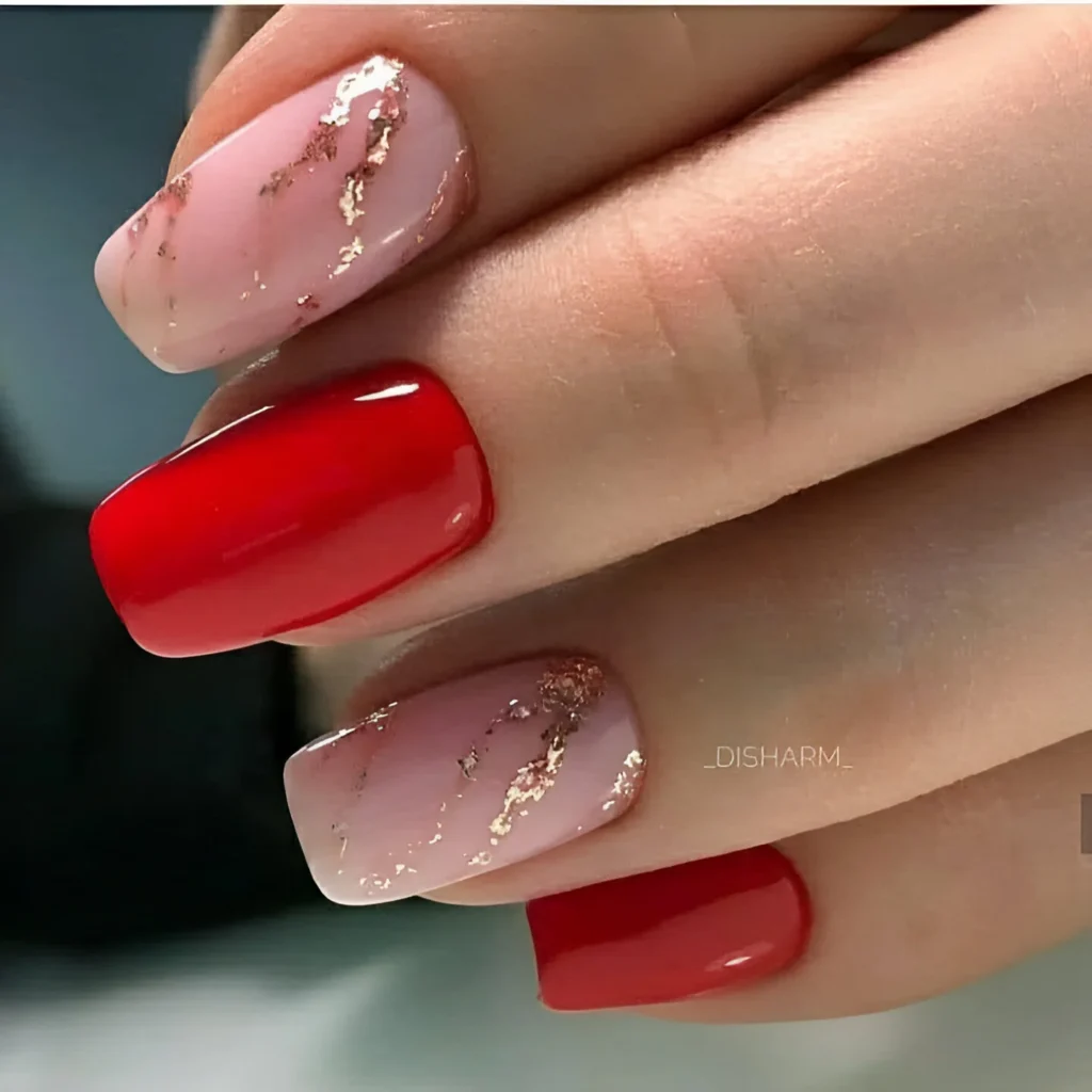 Red and pink marble nail designs with gold accents.