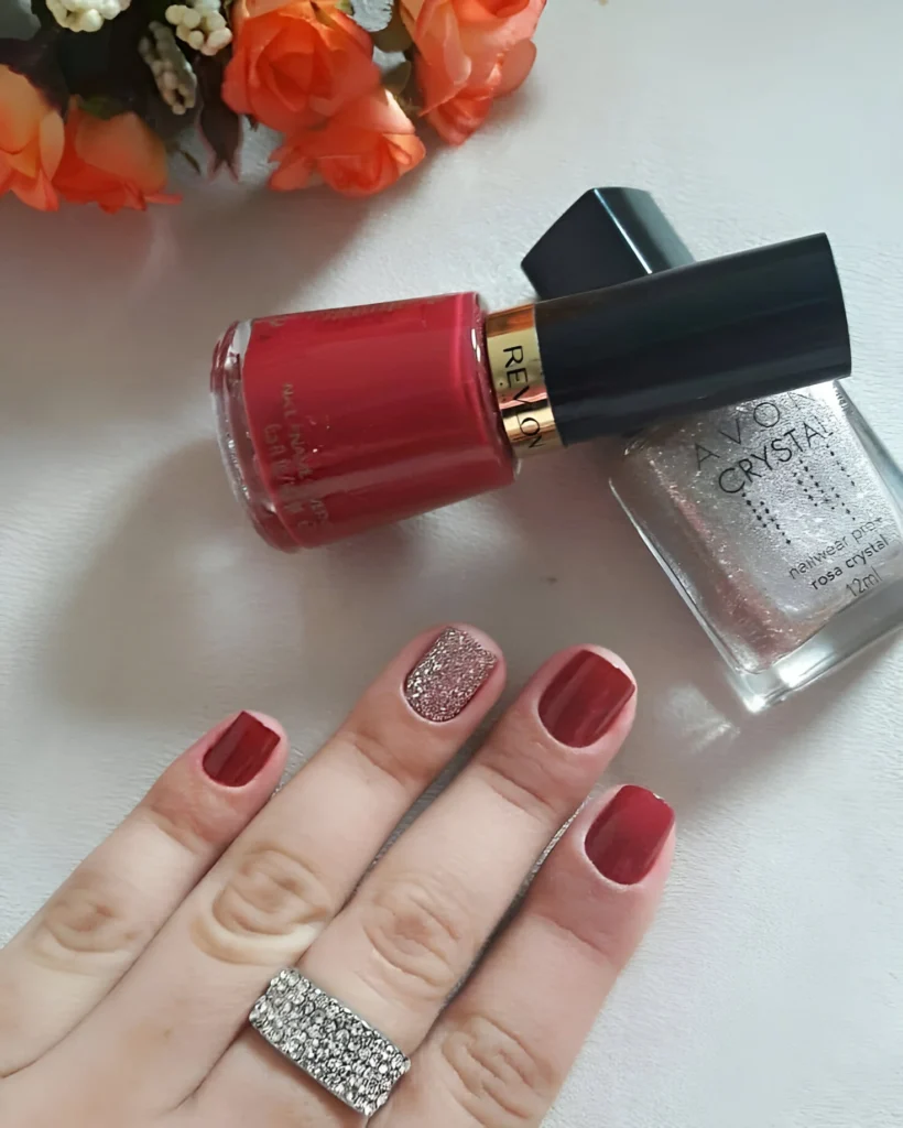 Classic red nails with a glitter accent for a chic and modern touch.