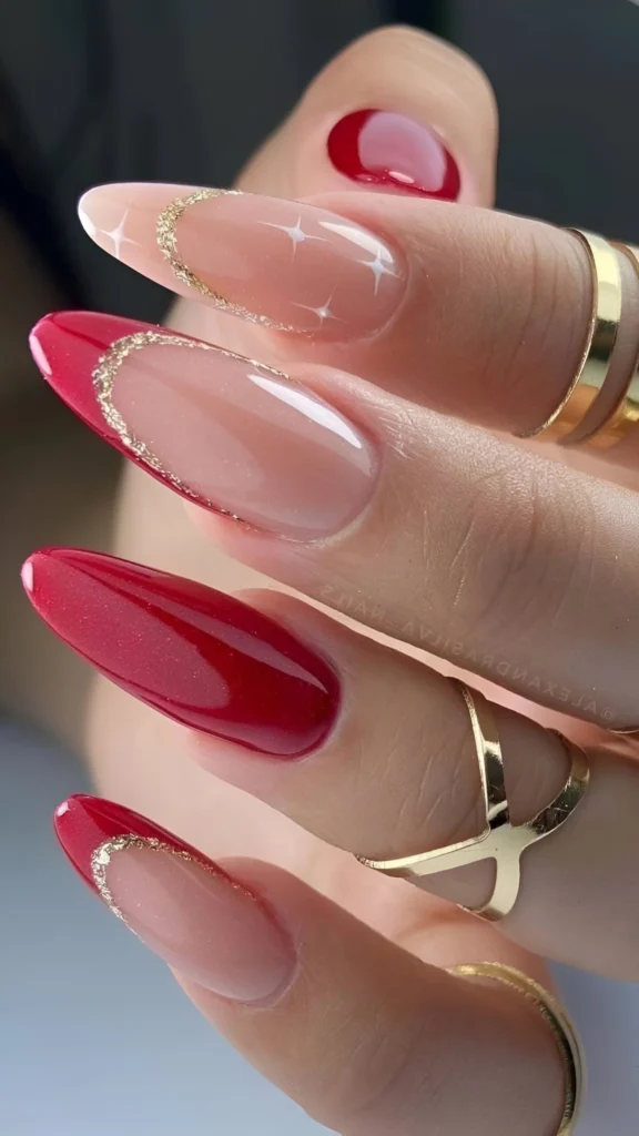 Elegant red almond nails with nude and gold accents for a refined look.