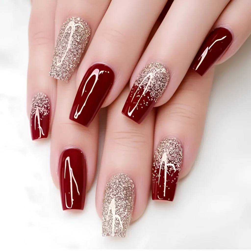 Garnet red nail designs with gold glitter ombre.