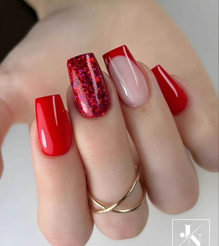 Red nail designs with glitter and French tip accents.