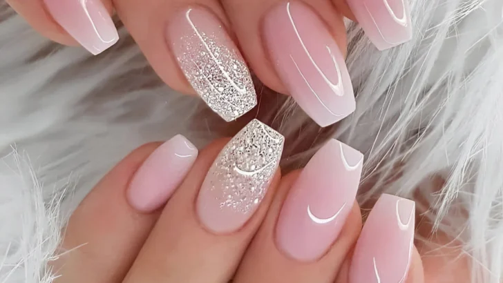 Milky pink coffin nails with pink ombre and silver glitter accents.