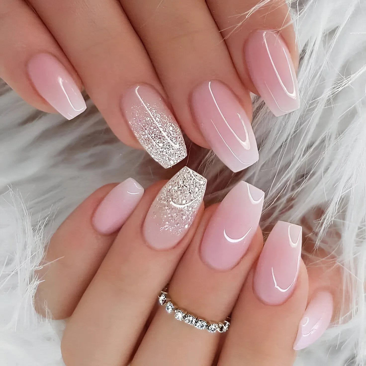 Milky pink coffin nails with pink ombre and silver glitter accents.