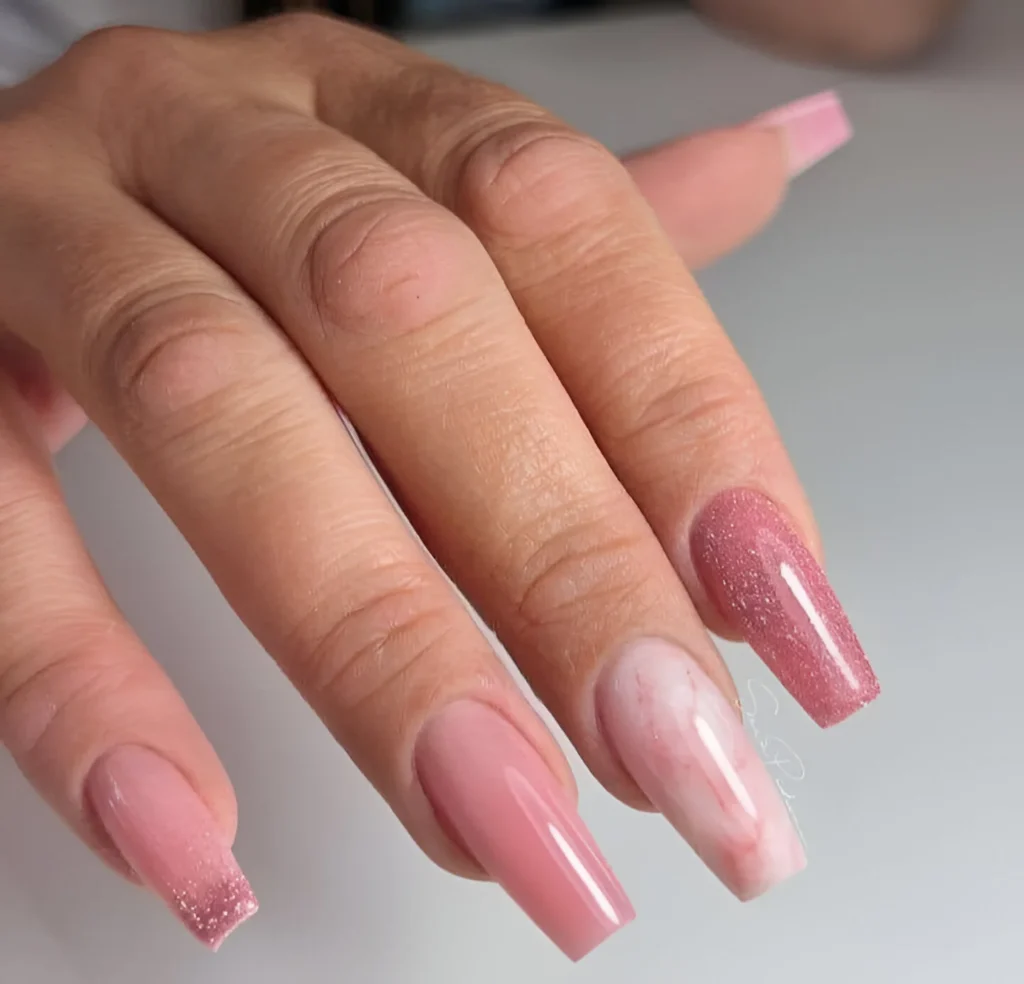 Long coffin nails with solid pink, glitter, and rose quartz accent nail.