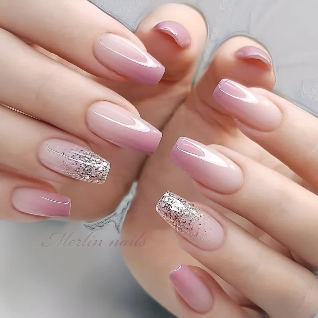 Nude to mauve ombre nails with a rose-gold textured glitter accent nail.