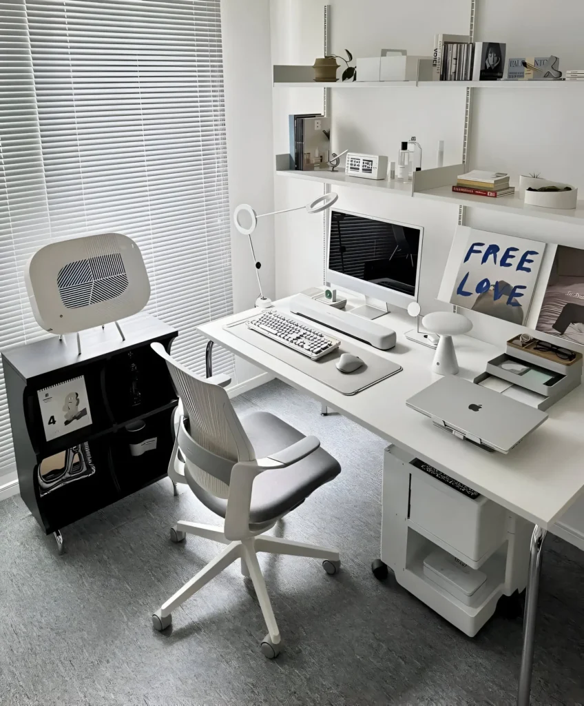 Minimalist desk setup with white and gray color scheme, computer, and desk organizers.