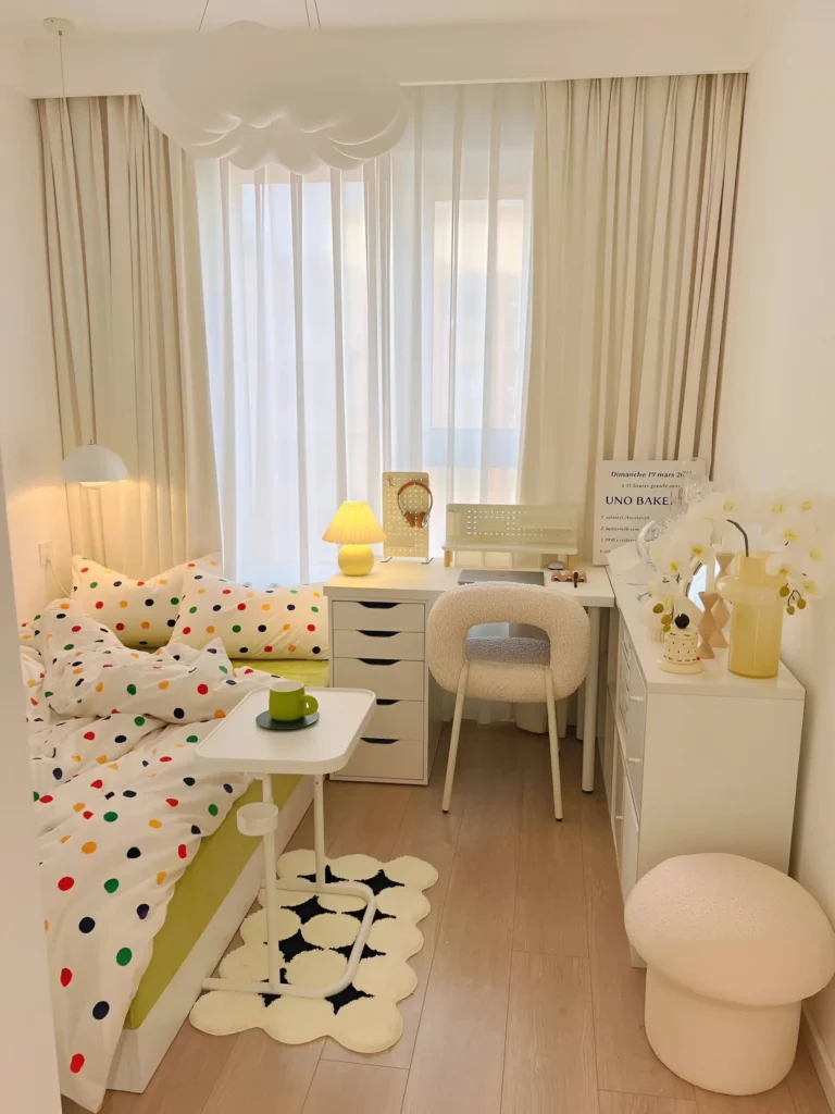 Small bedroom featuring a cloud-shaped ceiling light fixture and a small, round table with a yellow lamp. The bedding has colorful polka dots. Aesthetic Small Bedroom Ideas