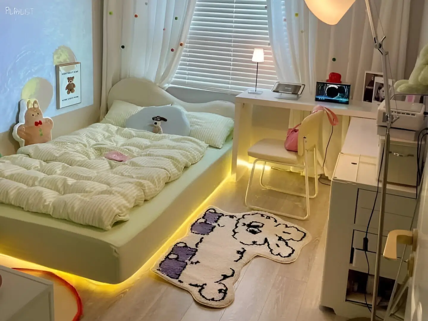 Small bedroom featuring ambient lighting, including under-bed lights and a desk lamp, creating a cozy atmosphere. Light green bedding and a whimsical rug add personality.