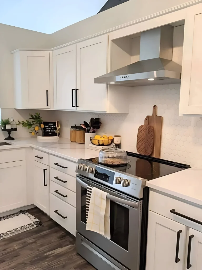 White modern farmhouse kitchen with black hardware, stainless steel appliances, and cozy wooden accents.